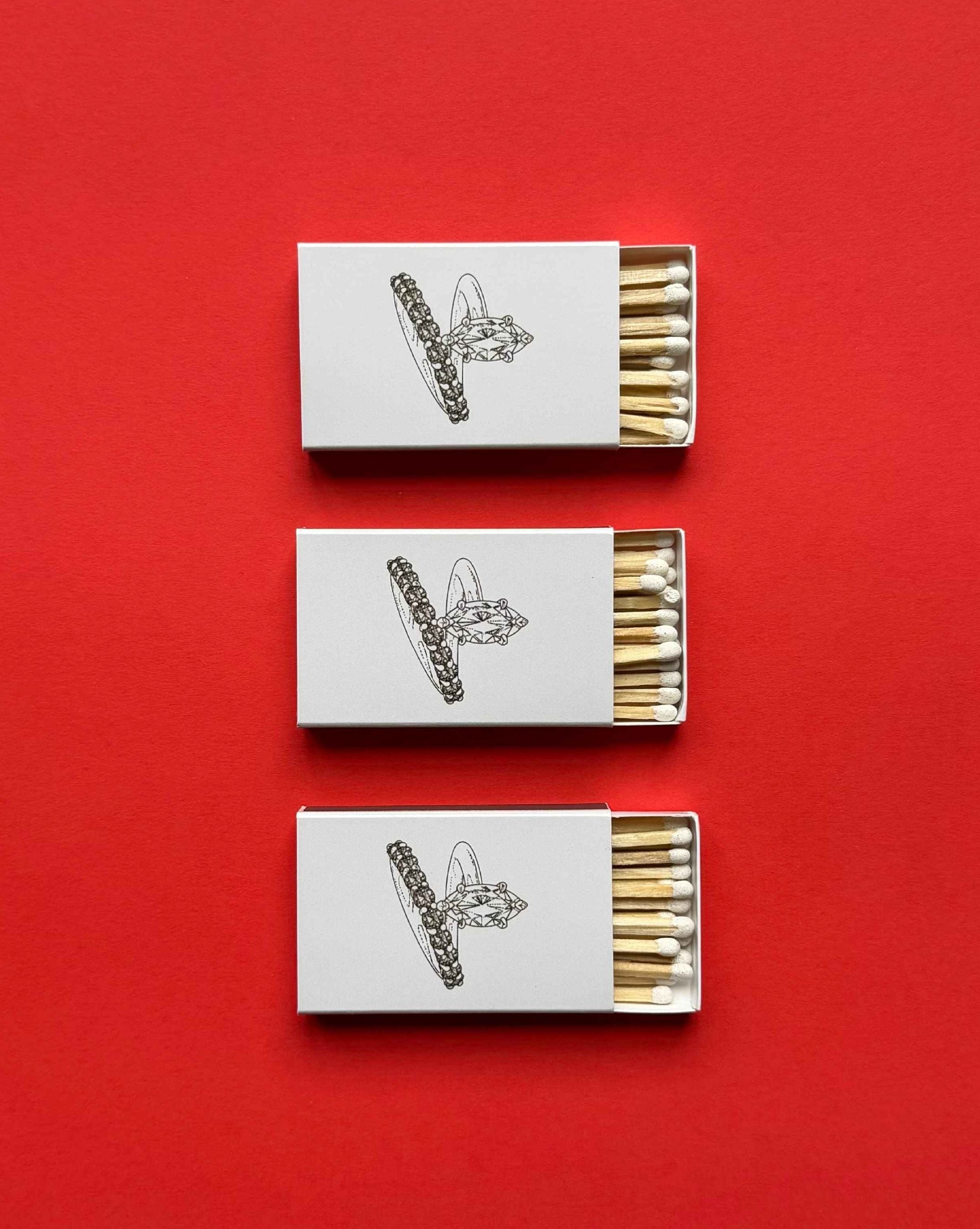 Classic custom-printed matchboxes created for luxury jewellery label Natasha Schweitzer